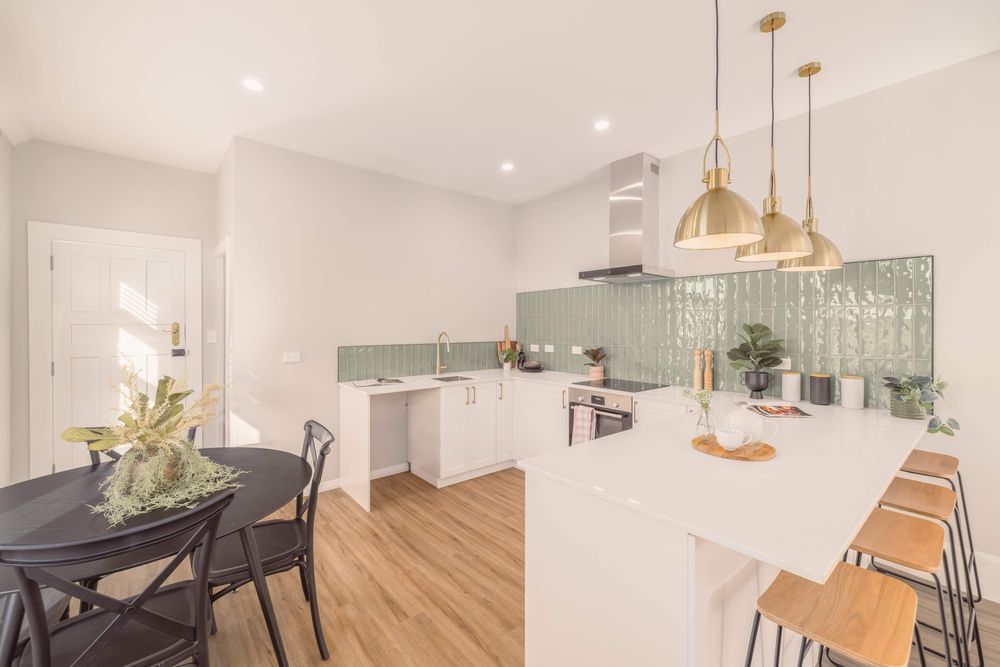 Conway Street kitchen with green splashback and brass pendants