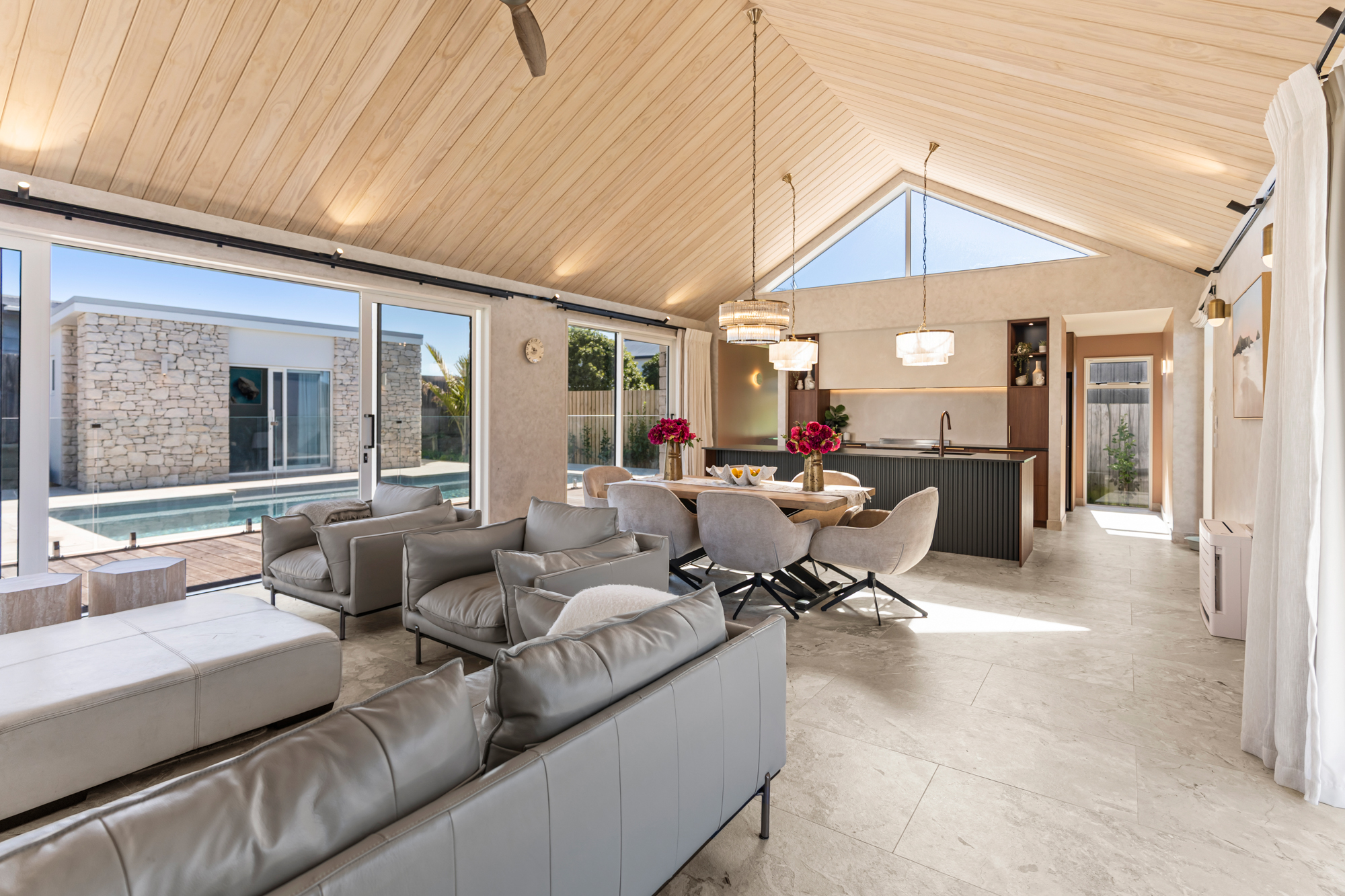 Marine Parade Christchurch - open-plan living and dining with vaulted cedar ceiling and pool view
