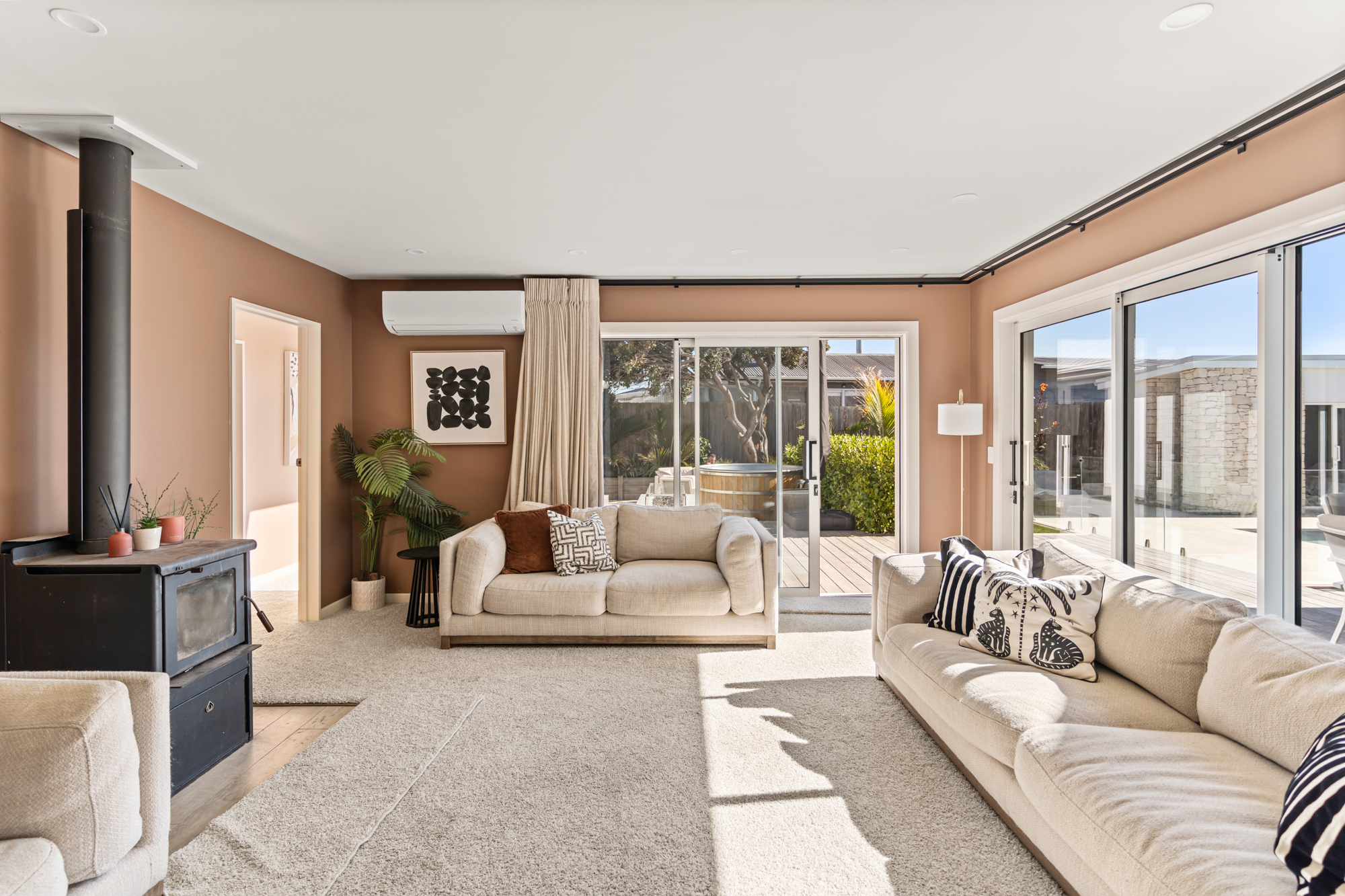 Marine Parade - second living room with fireplace and warm coastal palette