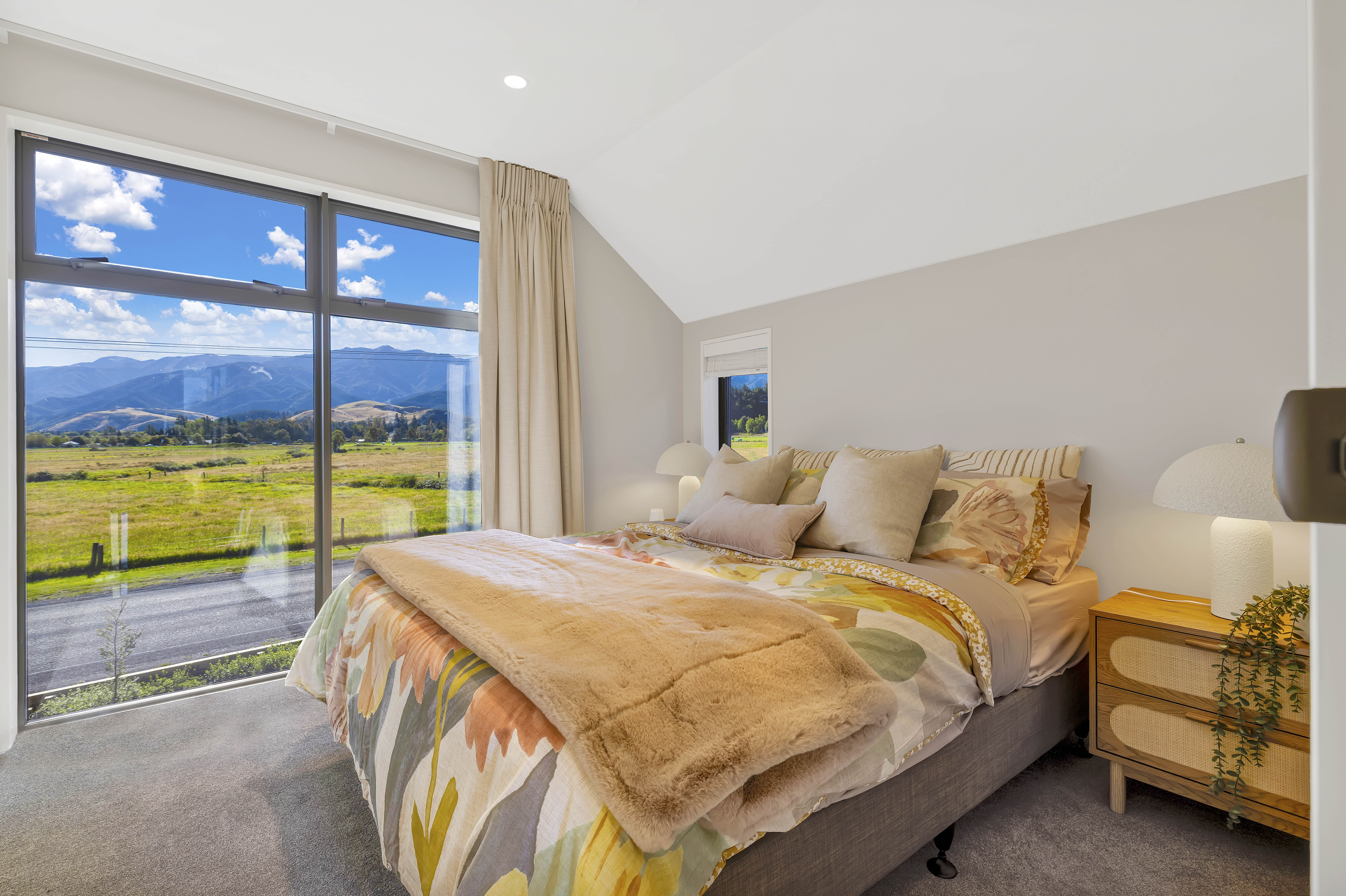 Travers Way - master bedroom with vaulted ceiling and mountain views